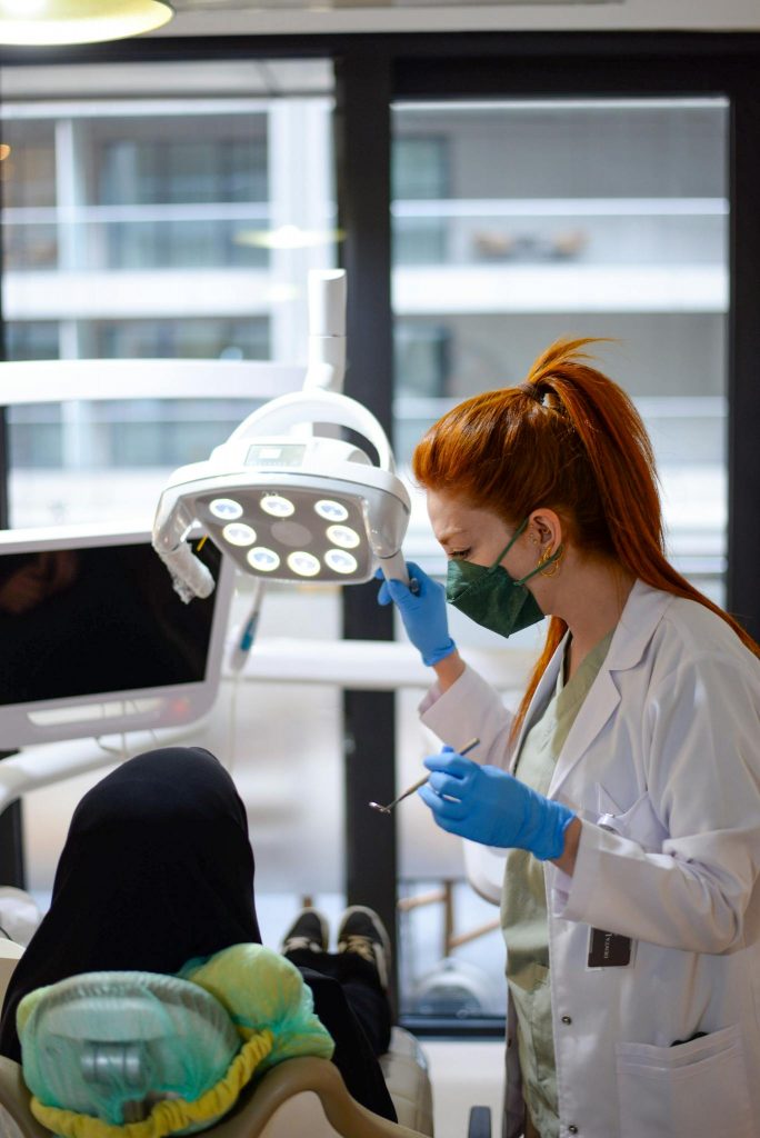 Female dentist attends to a patient in İstanbul clinic, focusing on dental procedure.